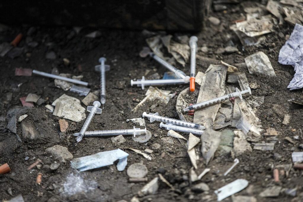 FILE – In this Feb. 2, 2017, file photo, used needles litter the ground at an open air drug market along Conrail train tracks in the Kensington section of Philadelphia. Drug overdose deaths in the U.S. skyrocketed 21 percent in 2016, dragging down life expectancy predictions for a second straight year, according to a report released by the Centers for Disease Control and Prevention on Thursday, Dec. 21, 2017. (Michael Bryant /The Philadelphia Inquirer via AP, File)