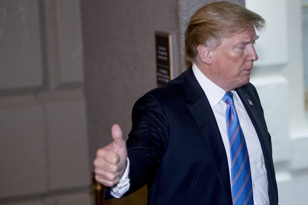 President Donald Trump gives a thumbs up as he arrives on Capitol Hill in Washington, Tuesday, June 19, 2018, to rally Republicans around a GOP immigration bill. (AP Photo/J. Scott Applewhite)