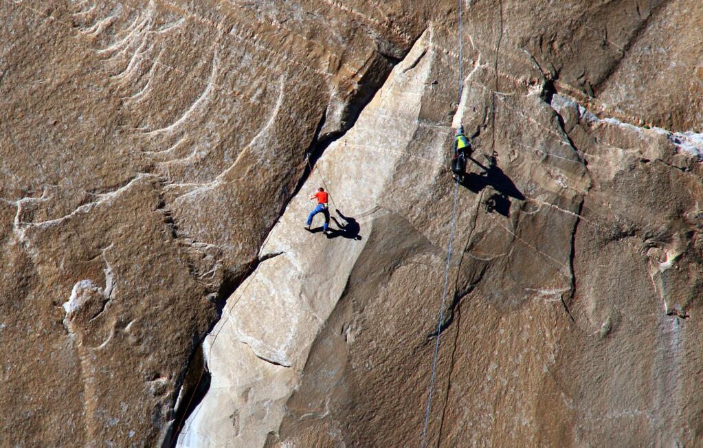 In this Dec. 28, 2014 photo provided by Tom Evans, Tommy Caldwell ascends what is known as pitch 10 on what has been called the hardest rock climb in the world: a free climb of a El Capitan, the largest monolith of granite in the world, a half-mile section of exposed granite in California's Yosemite National Park. (AP Photo/Tom Evans, elcapreport)