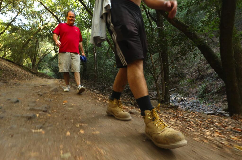 Rick Gittings of San Diego hikes behind his son Charlie from Lake Ilsanjo along the Spring Creek Trail in Annadel State Park on Thursday. (JOHN BURGESS / The Press Democrat)
