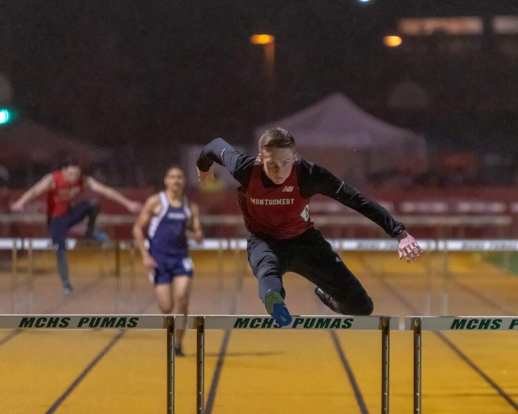 Brent Oru-Craig of Montgomery High School competes in the hurdles at the Santa Rosa Twilight Invitational held Friday, March 22, at Maria Carrillo High School. (Brian Tucker)