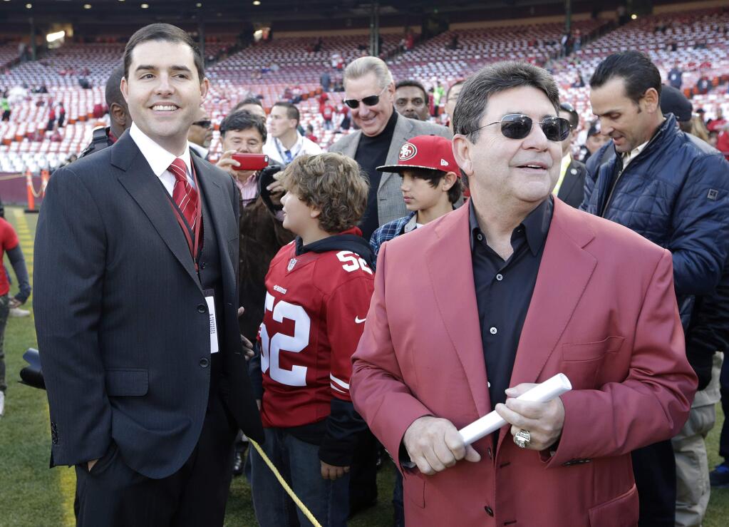 San Francisco 49ers owner Jed York, left, and former owner Eddie DeBartolo Jr., right, stand on the field at Candlestick Park before an NFL football game between the San Francisco 49ers and the Atlanta Falcons in San Francisco, Monday, Dec. 23, 2013. (AP Photo/Tony Avelar)