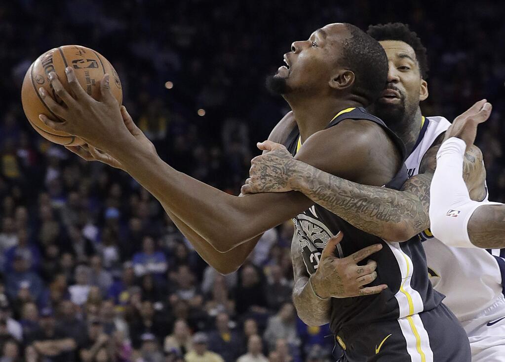 Golden State Warriors forward Kevin Durant, left, is fouled by Denver Nuggets forward Wilson Chandler during the second half in Oakland, Saturday, Dec. 23, 2017. The Nuggets won 96-81. (AP Photo/Jeff Chiu)