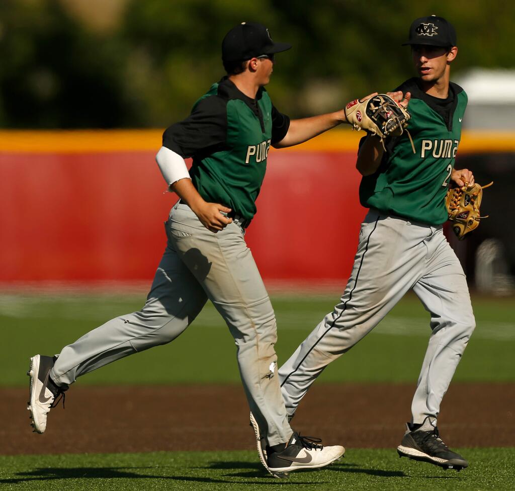 Maria Carrillo's KC Kelly (22), left, and Bryce Veler (2) high-five after Kelly made an out to close the inning during a varsity baseball game between Maria Carrillo and Cardinal Newman high schools in Santa Rosa, California, on Friday, May 10, 2019. (Alvin Jornada / The Press Democrat)