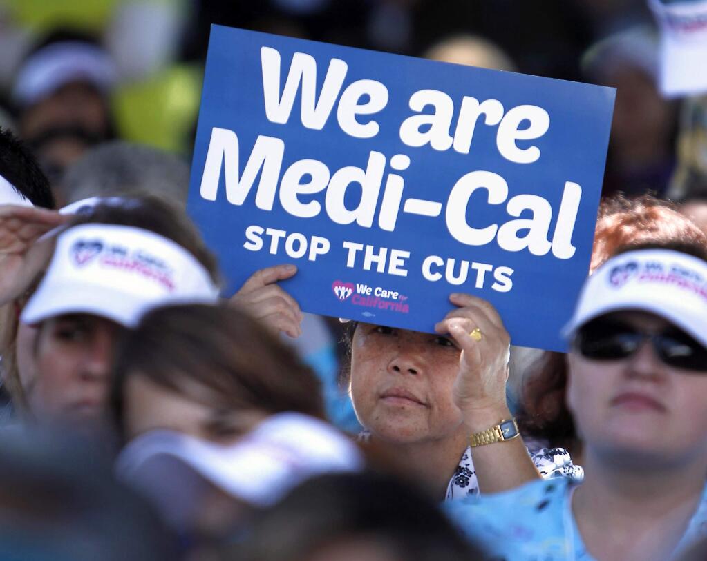 FILE - In this June 4, 2013, file photo, demonstrators representing doctors, hospitals and unionized health care workers rally against cuts in the amount the state pays for Medi-Cal reimbursements, at the Capitol in Sacramento, Calif. A judge has ruled that Los Angeles County wrongly canceled Medi-Cal coverage for thousands of residents, often leaving them without access to health care and needed medicines. The Los Angeles Times reports Sunday, May 13, 2018, that last week's ruling said the county violated state law by terminating coverage for beneficiaries even though they turned in their renewal paperwork on time. (AP Photo/Rich Pedroncelli, File)