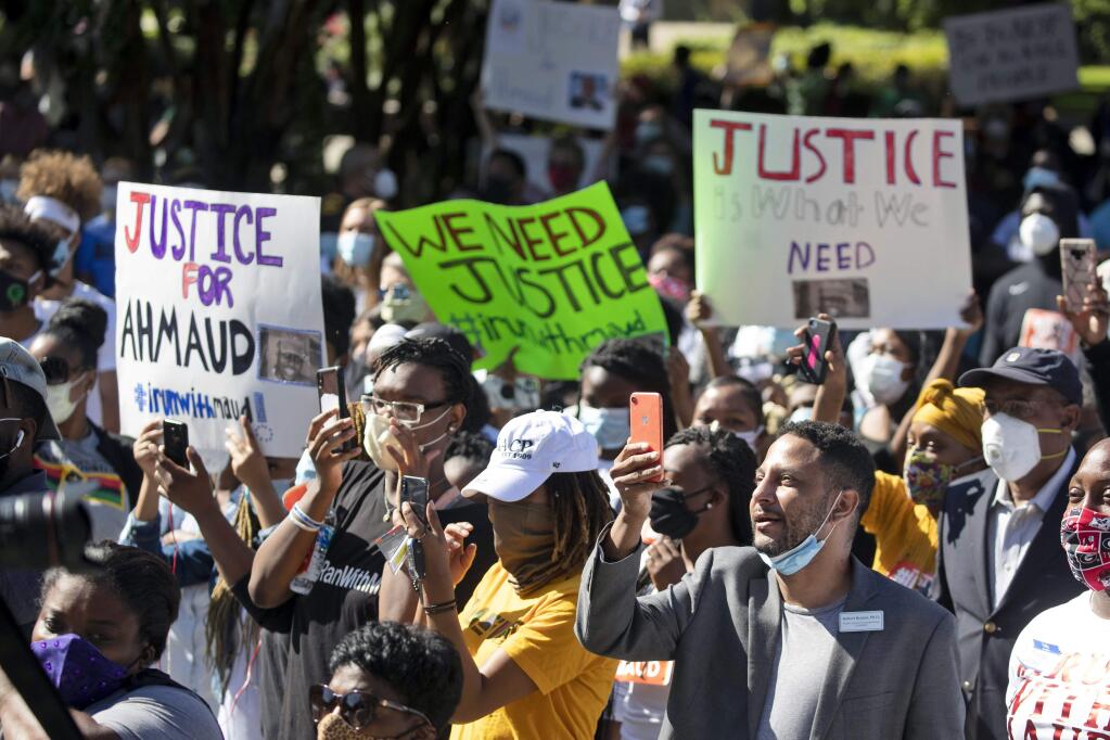 People react during a rally to protest the shooting of Ahmaud Arbery, Friday, May 8, 2020, in Brunswick Ga. Two men have been charged with murder in the February shooting death of Arbery, a black man in his mid-20s, whom they had pursued in a truck after spotting him running in their neighborhood. (AP Photo/John Bazemore)