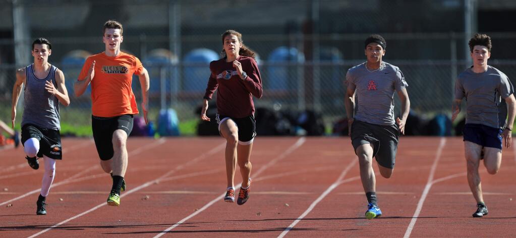 Kirsten Carter, middle, runs sprints with her Santa Rosa High School teammates Nathaniel Seims, Brayden Glascock, Trevien Prince and Rob Bailey, Monday March 26, 2018 in Santa Rosa. Carter held the nation's fastest time this year in the 300-meter hurdles, but only for 24 hours, when two other high schoolers eclipsed her time. (Kent Porter / Press Democrat)