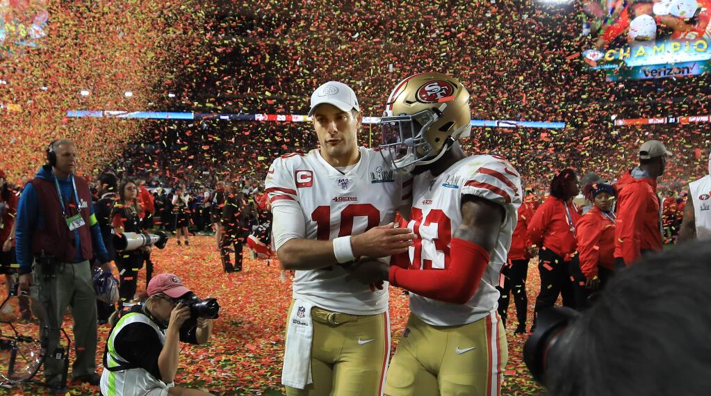 49ers quarterback Jimmy Garoppolo walks arm and arm off the field with Tavarius Moore, right, after San Francisco's 31-20 Super Bowl loss to the Kansas City Chiefs, Sunday, Feb 2, 2020 in Miami Gardens. (Kent Porter / The Press Democrat) 2020