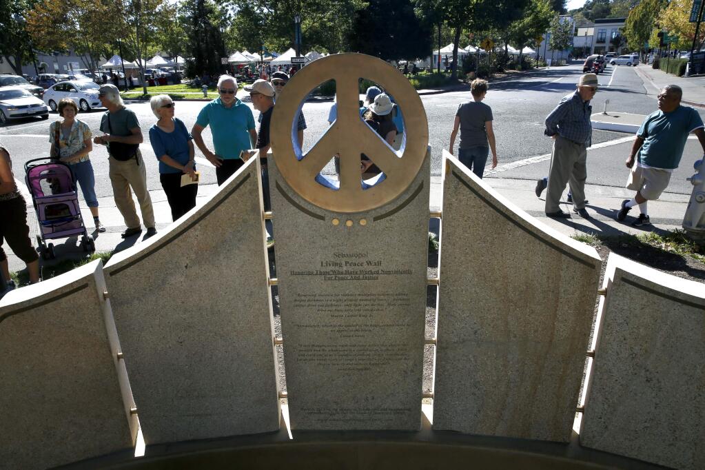 A crowd gathers during the dedication of the Living Peace Wall on Sunday, October 11, 2015 in Sebastopol, California . (BETH SCHLANKER/ The Press Democrat)