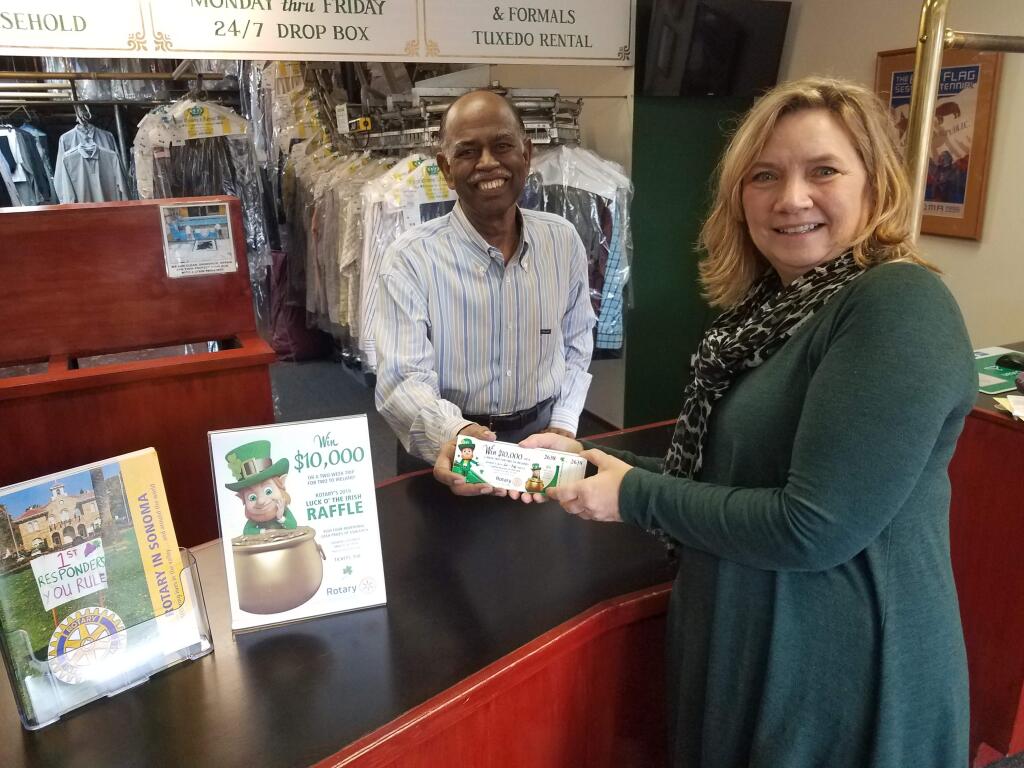 Rotary's raffle chairperson Beth Fox drops off a set of tickets to club member Kanak Raj, of Crown Cleaners, who led the pack last year by selling nearly 200 tickets.