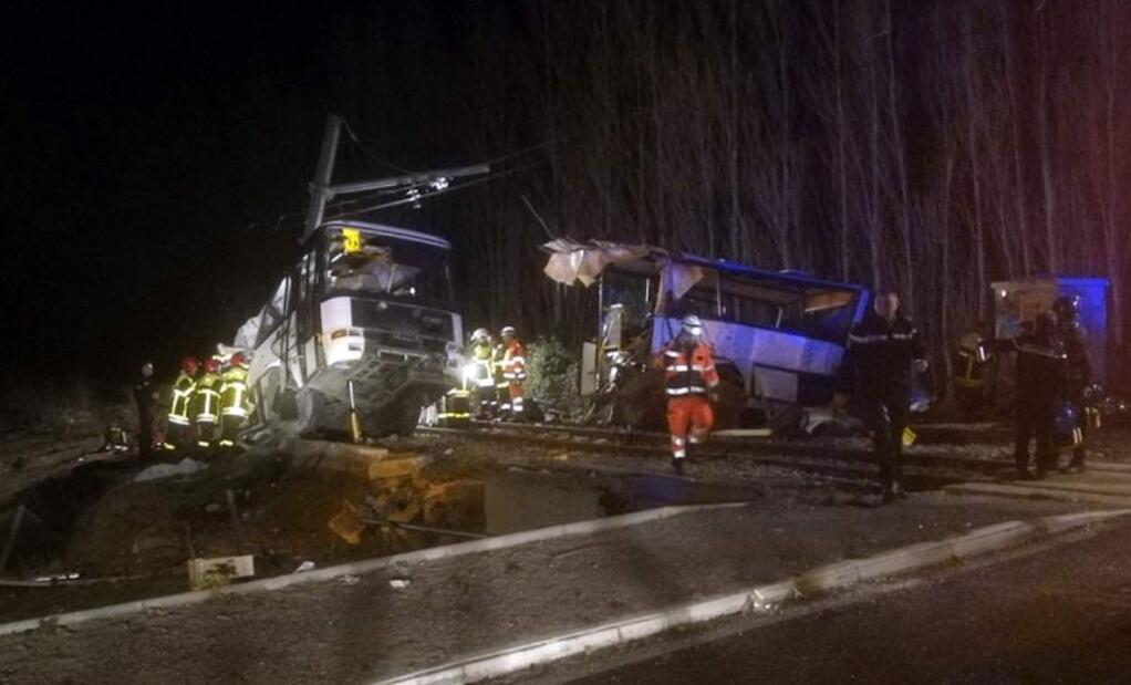 In this photo provided by France Bleu, rescue workers help after a school bus and a regional train collided in the village of Millas, southern France, Thursday, Dec. 14, 2017. A school bus and a regional train collided in southern France on Thursday, killing four children and critically injuring several other people on the bus, the French interior ministry said. (Matthieu Ferri/France Bleu via AP)