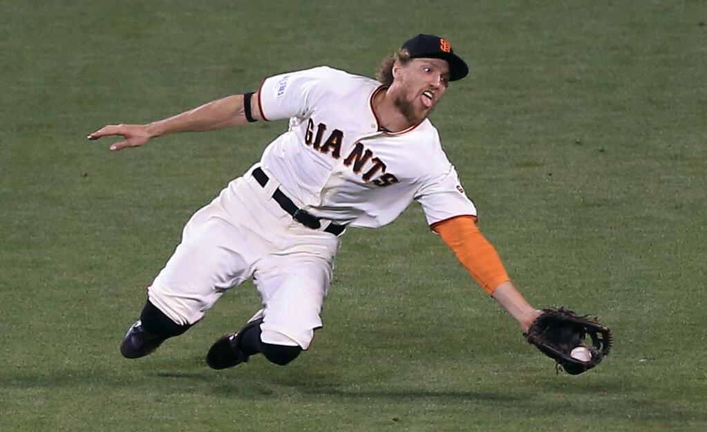 Hunter Pence makes a diving catch off a Lorenzo Cain blooper in the ninth inning for the second out during the Giants 11-4 win over the Royals in game 4 of the World Series in San Francisco, Saturday Oct. 25, 2014. (Kent Porter / Press Democrat) 2014