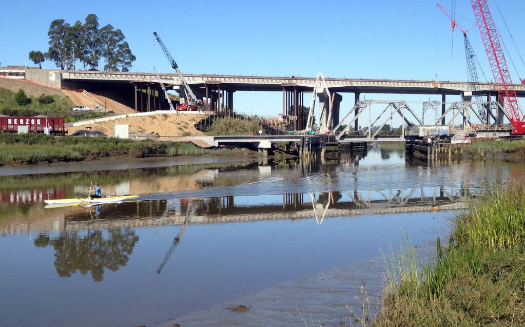 A boater paddles down the Petaluma river below the old train bridge that is possible to paddle under on Friday April 17, 2015. The new bridge which is set to be installed will be lower to the water and might not have enough room for paddlers to navigate under in the future. (SCOTT MANCHESTER/ARGUS-COURIER STAFF)