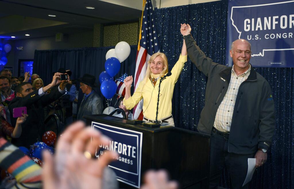 Greg Gianforte, right, and wife Susan, center, celebrate his win over Rob Quist for the open congressional seat at the Hilton Garden Inn Thursday night, May 25, 2017, in Bozeman, Mont. Gianforte, a technology entrepreneur, defeated Democrat Quist to continue the GOP's two-decade stronghold on the congressional seat. (Rachel Leathe/Bozeman Daily Chronicle via AP)