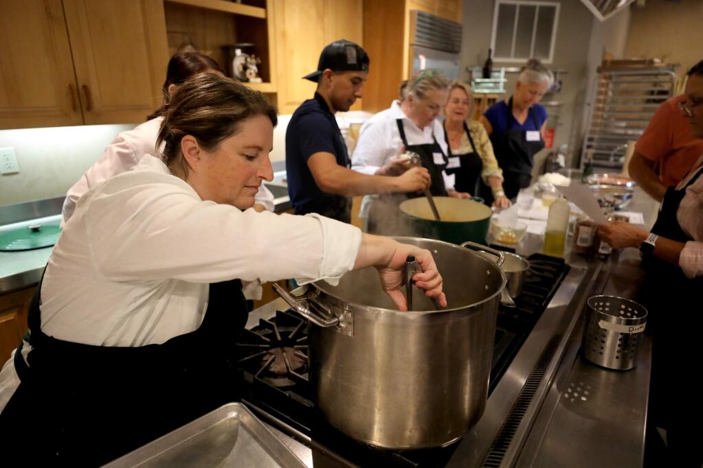 Chef Annie Simmons checks on artichokes boiling in water during a 'Cowboy Cuisine' cooking class at Ramekins Culinary School in Sonoma on Sunday, Sept. 22, 2019. (BETH SCHLANKER/ PD)