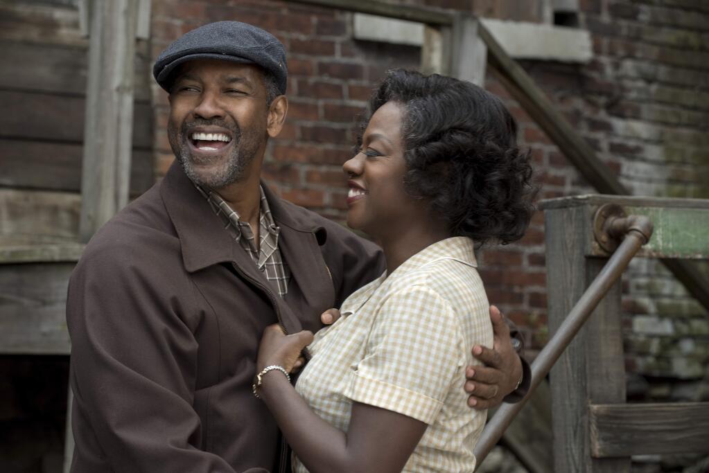 This image released by Paramount Pictures shows Denzel Washington, left, and Viola Davis in a scene from, 'Fences.' Adapting Wilson‚Äôs masterpiece has taken more than 30 years. Washington, who directed the film and starred on Broadway revival of ‚ÄúFences‚Äù seven years ago, made some key decisions when he was first tapped to translate the play onto celluloid. He reunited five of the main actors; Viola Davis, Stephen McKinley Henderson, Russell Hornsby and Mykelti Williamson. (David Lee/Paramount Pictures via AP)