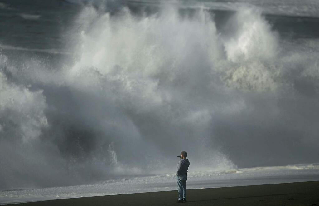 Guerneville resident Max Kline videotapes huge waves crashing in to Goat Rock State Beach in Jenner in 2009. (Kent Porter / The Press Democrat)