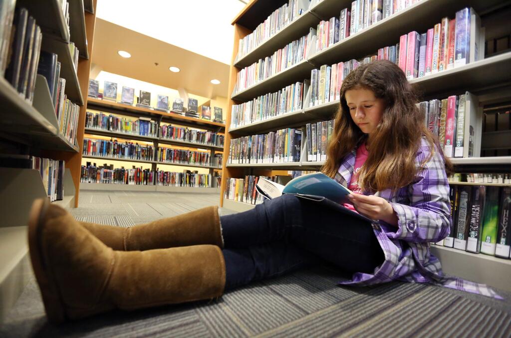 Alexandra Antonetti, a student at Lawrence E. Jones Middle School, reads at the Rohnert Park-Cotati Library in 2015. (CRISTA JEREMIASON/ PD FILE)