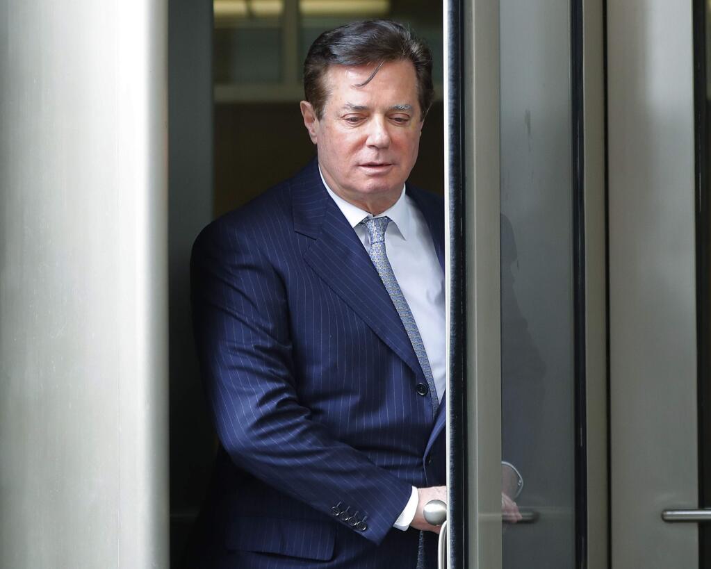 Paul Manafort, President Donald Trump's former campaign chairman, leaves the federal courthouse in Washington, Wednesday, Feb. 14, 2018. (AP Photo/Pablo Martinez Monsivais)