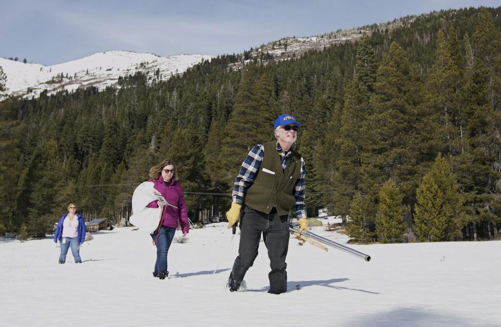 Frank Gehrke, right, chief of the California Cooperative Snow Surveys Program, for the Department of Water Resources, crosses a snow covered meadow as he conducts the second snow survey of the season Thursday, Feb. 1, 2018, near Echo Summit, Calif. The snow survey showed the snow pack at this location was 13.6 inches of deep with a water content of 2.6 inches. Accompanying Gehrke are Michelle Mead, left, and Courtney Obergfell, both of the National Weather Service. (AP Photo/Rich Pedroncelli)