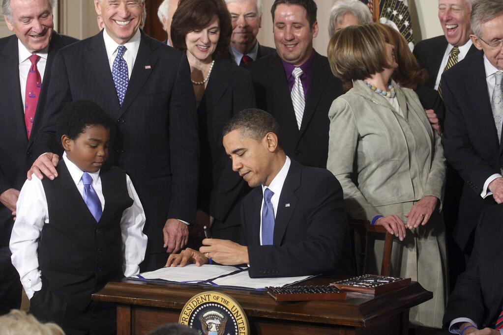 President Barack Obama signs the Affordable Care Act into law on March 23, 2010. House Republicans plan to vote today to repeal the law. (DOUG MILLS / New York Times)