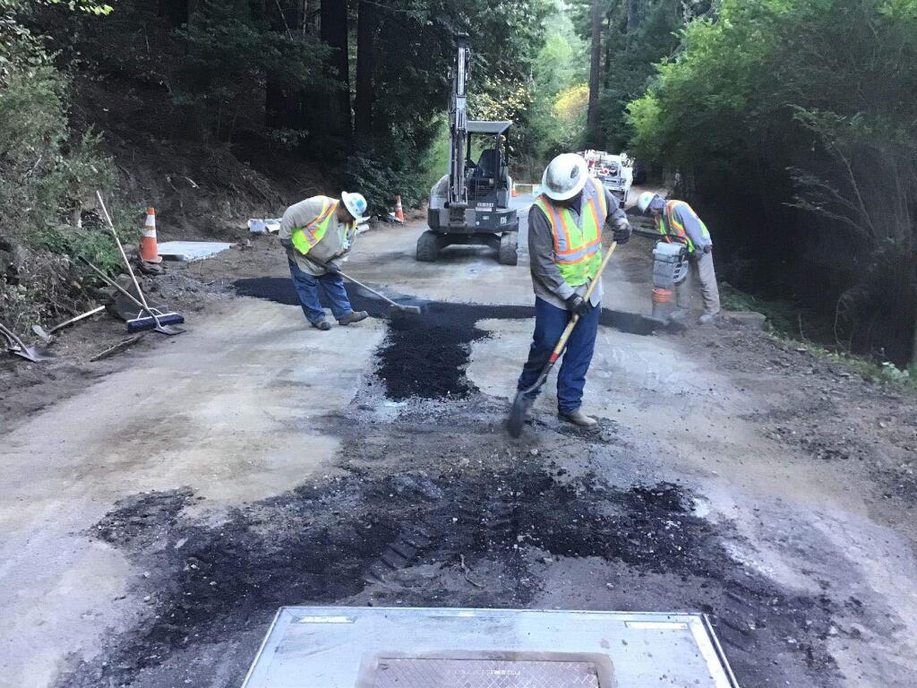 PG&E contract crews spread asphalt over an excavation on Bohemian Highway last month as part of a test project to put a half-mile of power lines underground. (PG&E)