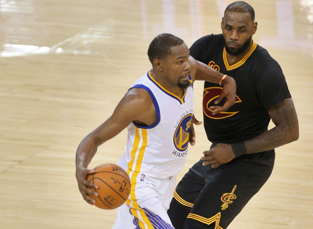 Golden State Warriors forward Kevin Durant drives past Cleveland Cavaliers forward LeBron James during game 2 of the NBA Finals in Oakland on Sunday, June 4, 2017. The Warriors defeated the Cavaliers 132-113. (Christopher Chung/ The Press Democrat)