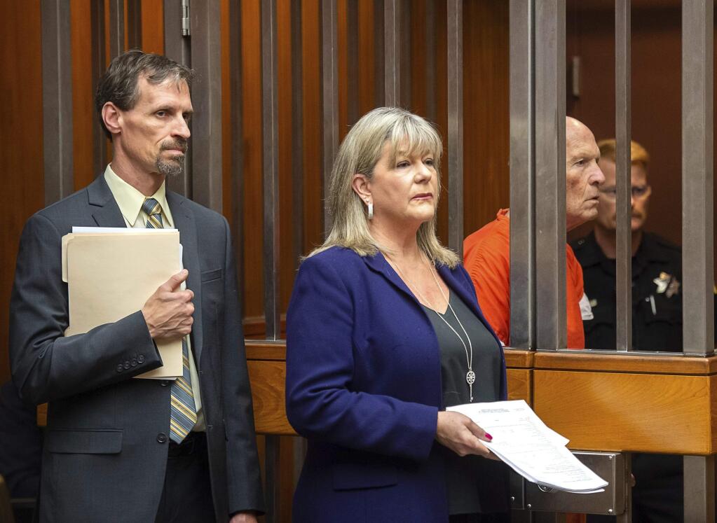 Public defender Diane Howard, center, and Joe Cress, left, stand with Joseph James DeAngelo, nicknamed the Golden State Killer and the East Area Rapist, during his hearing in Sacramento, Calif., on Thursday, Dec. 6, 2018. The former police officer is suspected of being a notorious serial killer who terrorized California in the 1970s and 80s. (Paul Kitagaki Jr./The Sacramento Bee via AP, Pool)
