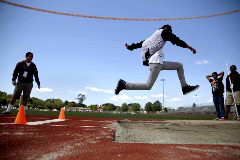 Jose Tapia, 15, competes in the long jump during a Special Olympic track and field competition at Montgomery High School in Santa Rosa, on Thursday, May 7, 2015. (BETH SCHLANKER/ The Press Democrat)