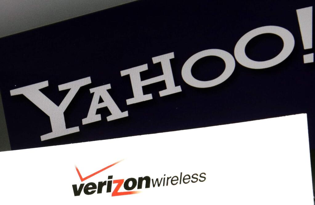 FILE - This Monday, July 25, 2016, file photo shows the Yahoo and Verizon logos on a laptop, in North Andover, Mass. (AP Photo/Elise Amendola, File)