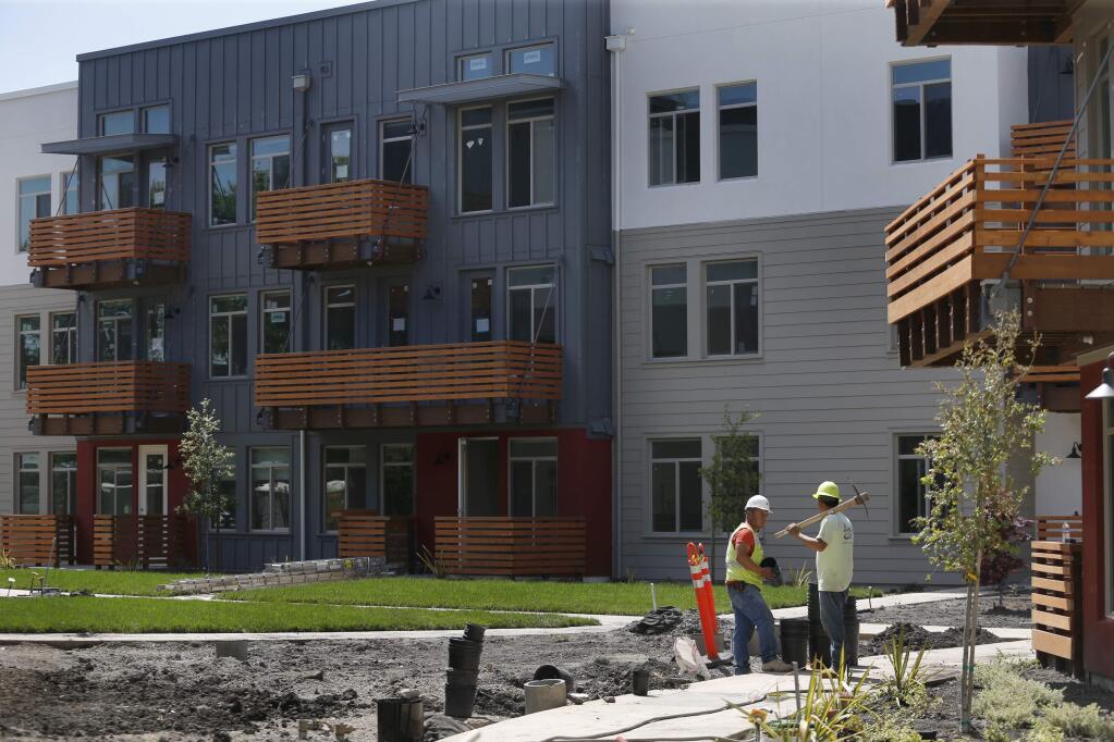 Landscapers work outside new units of the Annadel apartment complex on Monday, April 30, 2018 in Santa Rosa, California . (BETH SCHLANKER/The Press Democrat)