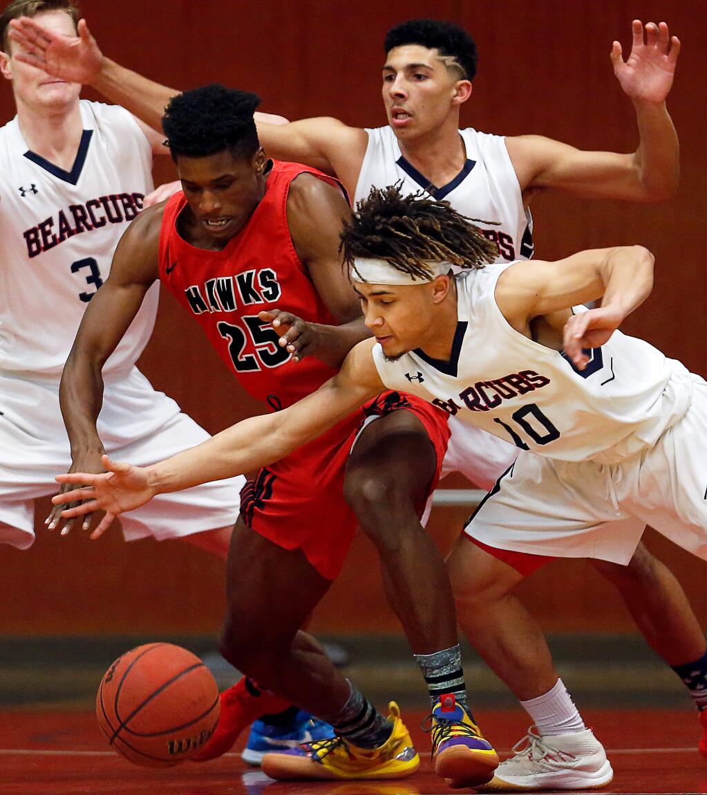 SRJC's Damian Wallace (10), lower right, steals the ball from Las Positas's Michael Hayes (25) during the first half of the CCCAA mens basketball first round playoff game between Las Positas College Hawks and SRJC Bear Cubs at Haehl Pavilion in Santa Rosa, California, on Friday, March 1, 2019. (Alvin Jornada / The Press Democrat)