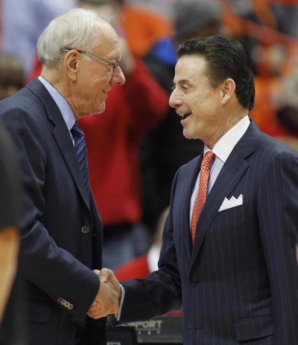 Syracuse head coach Jim Boeheim, left, and Louisville head coach Rick Pitino, right, shake hands before a game in Syracuse, N.Y., Monday, Feb. 13, 2017. (AP Photo/Nick Lisi)
