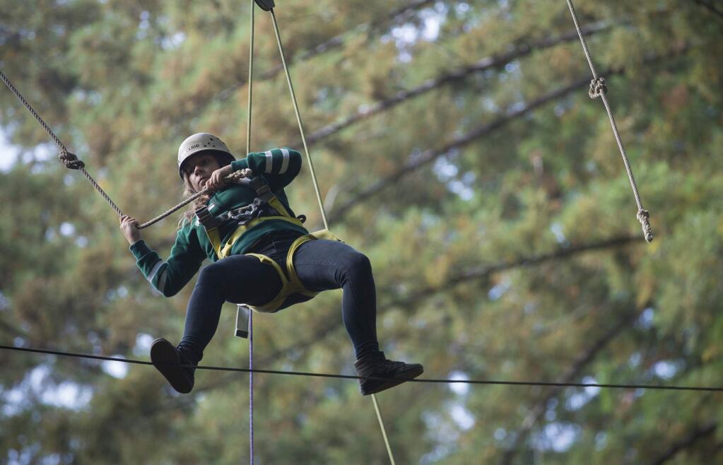 Balancing on a thin metal rope fifty feet in the air, the participants are safely harnessed and are never in any danger. (Photo by Robbi Pengelly/Index-Tribune)