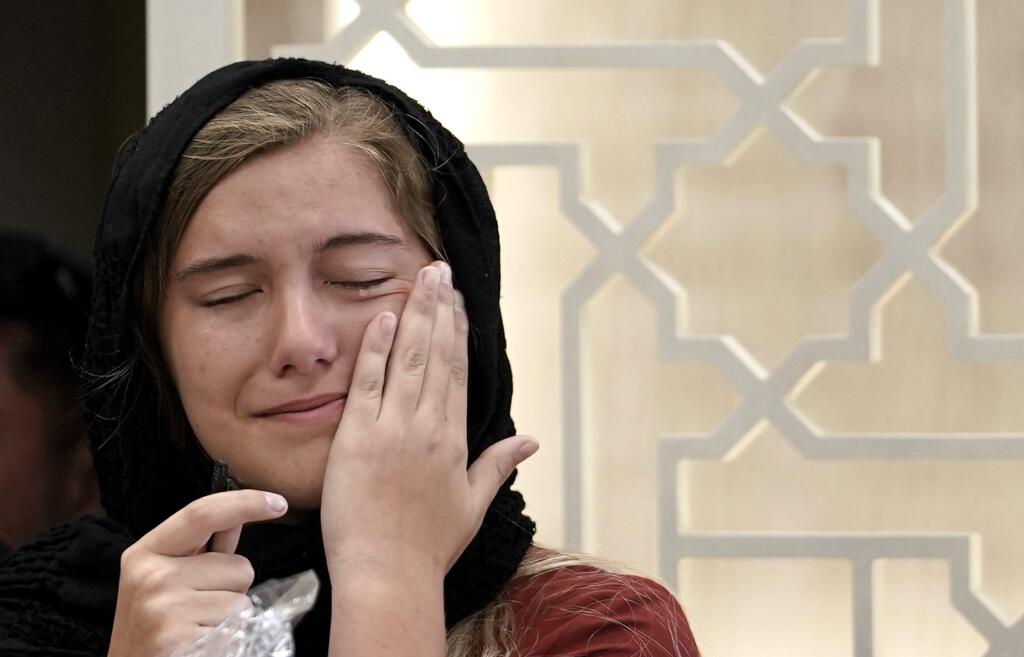 Santa Fe High School student Jaelyn Cogburn wipes away tears as she speaks about Pakistani exchange student Sabika Sheikh, who lived with her family, during a service at the Brand Lane Islamic Center Sunday, May 20, 2018, in Stafford, Texas. A gunman opened fire inside Santa Fe High School Friday, May 18, 2018, killing multiple people including Sheikh. (AP Photo/David J. Phillip)