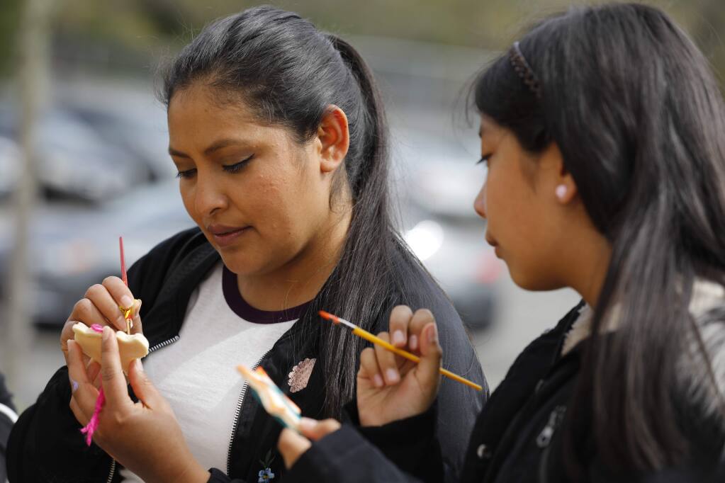 Fany Vargas, left, paints salt dough ornaments with her daughter Maria Perez Vargas, 10, during a Oaxacan Carnival and Health Fair event at the Healdsburg Community Center in Healdsburg, California on Sunday, April 7, 2019. (BETH SCHLANKER/The Press Democrat)