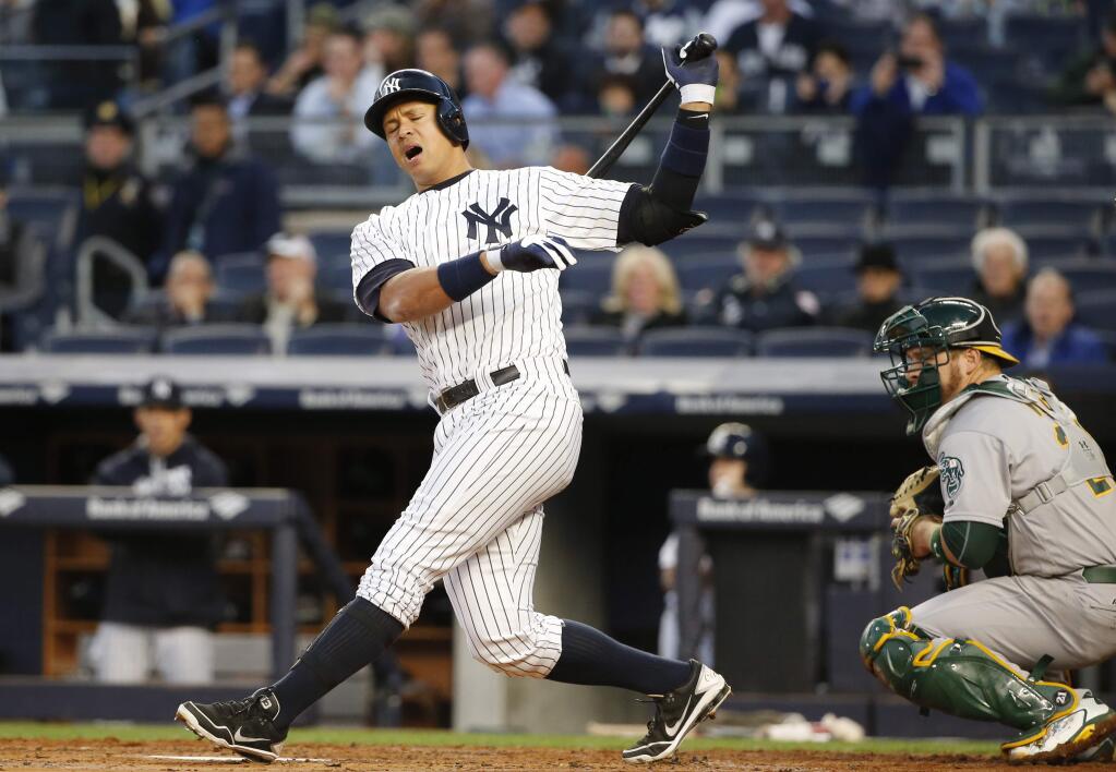 New York Yankees designated hitter Alex Rodriguez reacts in a first-inning at-bat against the Oakland Athletics in which he struck out with the bases loaded in a baseball game in New York, Wednesday, April 20, 2016. (AP Photo/Kathy Willens)