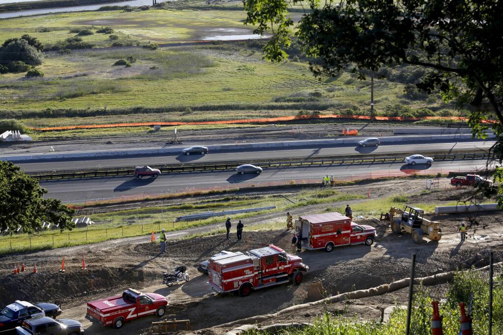 Emergency workers respond to the site where a 28-year-old construction worker died after he was crushed by rolling pipe at a road project southwest of the Petaluma Boulevard South exit off Highway 101 in Petaluma on Wednesday, April 15, 2015. (BETH SCHLANKER/ PD)