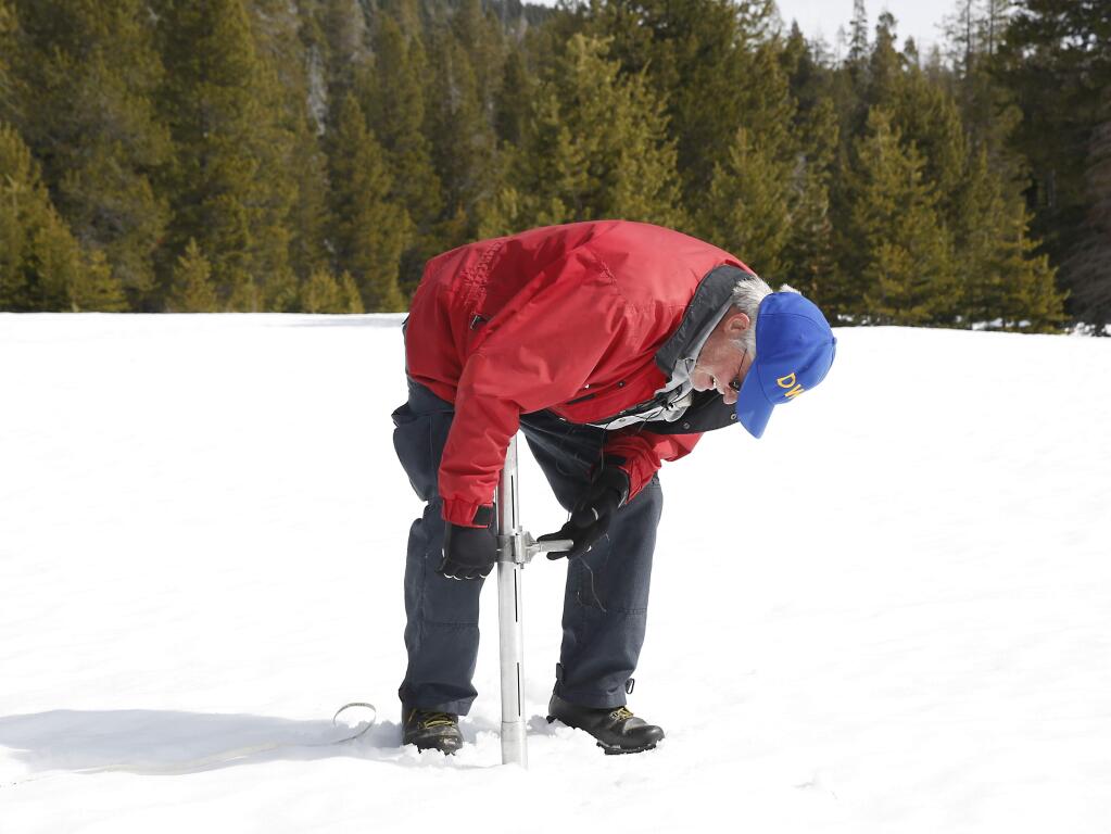 Frank Gehrke, chief of the California Cooperative Snow Surveys Program for the Department of Water Resources, checks the depth of the snowpack as he conducts the third manual snow survey of the season, at Phillips Station near Echo Summit, Calif., Tuesday, March 1, 2016. (AP Photo/Rich Pedroncelli)