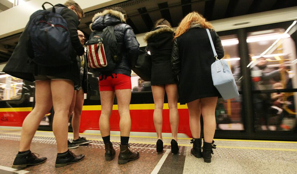 Participants in an international no pants stunt prepare to board a subway on Sunday Jan. 11, 2015. The stunt, which involves taking the subway without wearing trousers, took place Sunday across dozens of cities worldwide. Organizers call it a celebration of silliness. The prank took place in temperatures of 4 Celsius (37 Fahrenheit).(AP Photo/Czarek Sokolowski)