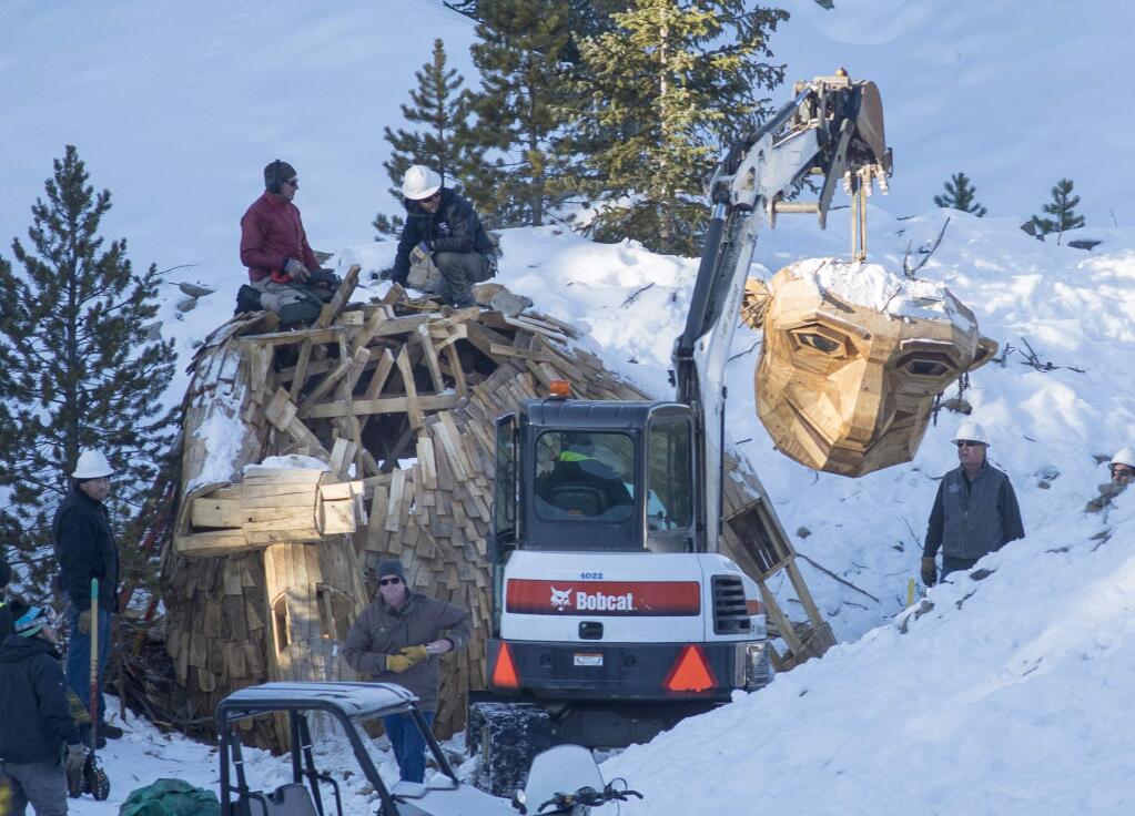 Thursday morning, Nov. 15, 2018, the Town of Breckenridge employees beheads 'Isak Hearthstone,' a wooden troll built by artist Thomas Dambo, by a chainsaw to remove it entirely from the Wellington Trail, in Breckenridge, Colo. The troll was created during the Breckenridge Festival of the Arts in August, but got so popular that it caused complaints from nearby homeowners due to tourists visiting, and demanded it to be removed. (Hugh Carey/Summit Daily News via AP)