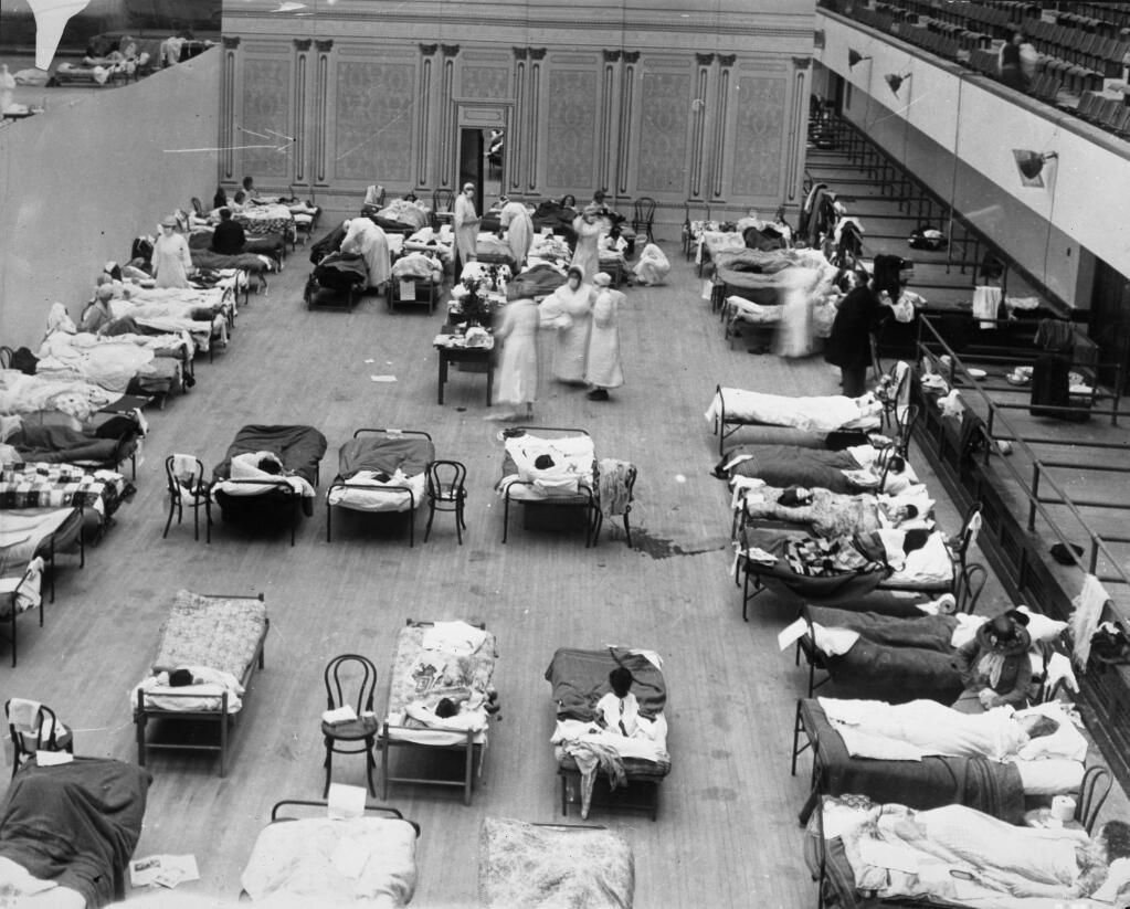 The Oakland Municipal Auditorium is used as a temporary hospital during the height of the flu epidemic in 1918. The hospital is staffed by Red Cross Volunteer nurses. (Photo by Edward A. 'Doc' Rogers. Public domain.)