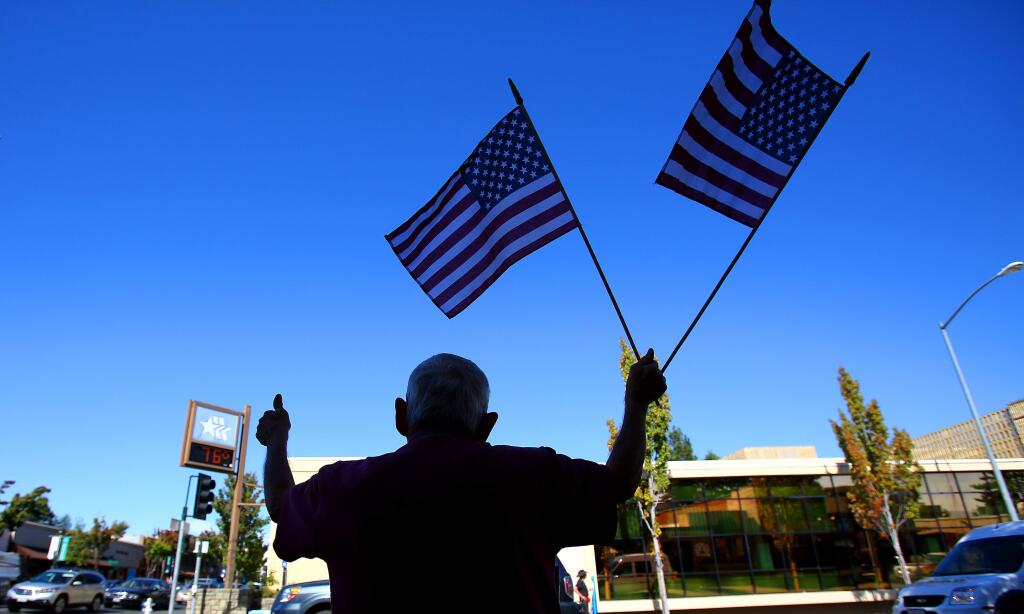 Nathan McMahon shows his support for the troops, across the street from the Women In Black, in downtown Sebastopol on Friday, Oct. 10, 2014. (CHRISTOPHER CHUNG/ PD)