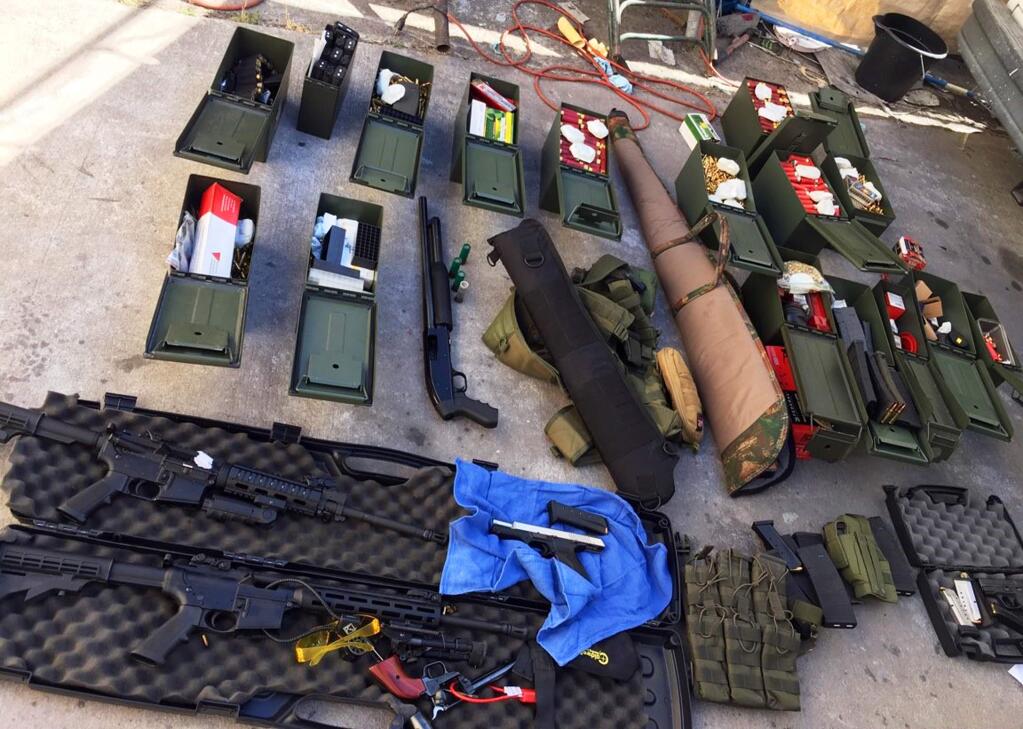 This undated photo released Wednesday, Aug. 21, 2019 by the Long Beach, Calif., Police Department shows weapons and ammunition seized from a cook at a Los Angeles-area hotel who allegedly threatened a mass shooting. Authorities say he had guns and hundreds of rounds of ammunition at his home. Rodolfo Montoya was arrested Tuesday, Aug. 20, 2019, a day after allegedly telling a co-worker at the Long Beach Marriott he planned to shoot fellow workers and others. (Long Beach Police Department via AP)