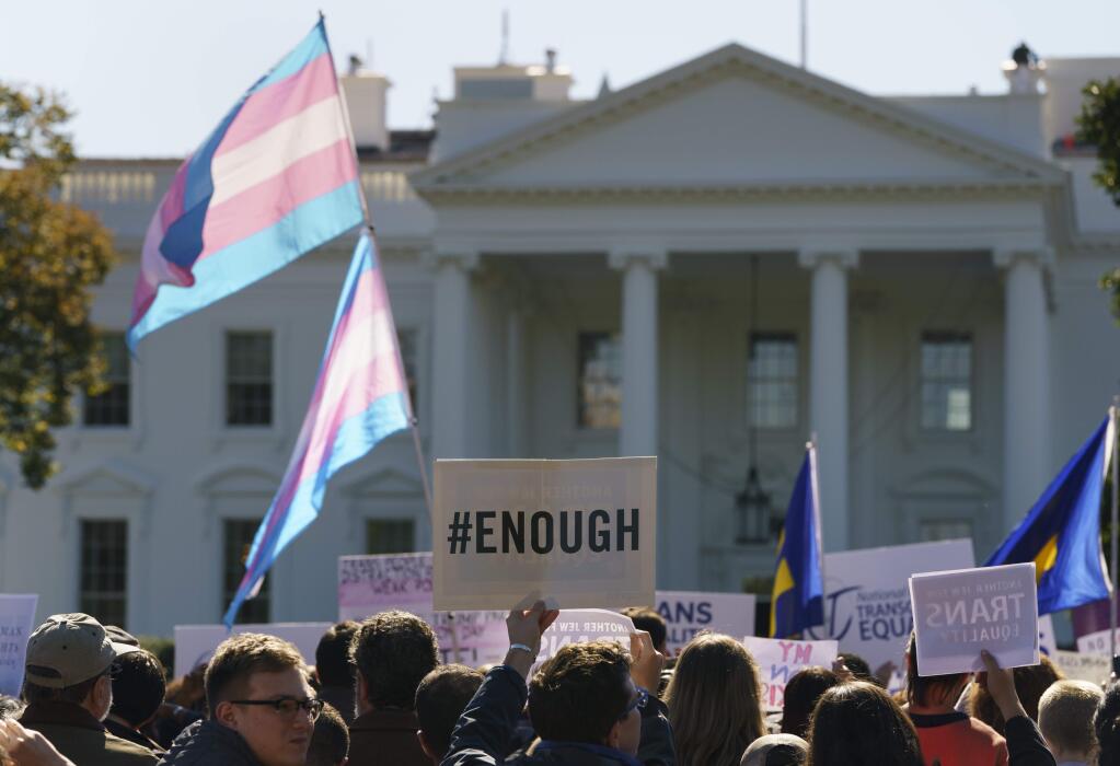 The National Center for Transgender Equality, NCTE, and the Human Rights Campaign gather on Pennsylvania Avenue in front of the White House in Washington, Monday, Oct. 22, 2018, for a #WontBeErased rally. Anatomy at birth may prompt a check in the 'male' or 'female' box on the birth certificate _ but to doctors and scientists, sex and gender aren't always the same thing. The Trump administration purportedly is considering defining gender as determined by sex organs at birth, which if adopted could deny certain civil rights protections to an estimated 1.4 million transgender Americans. (AP Photo/Carolyn Kaster)