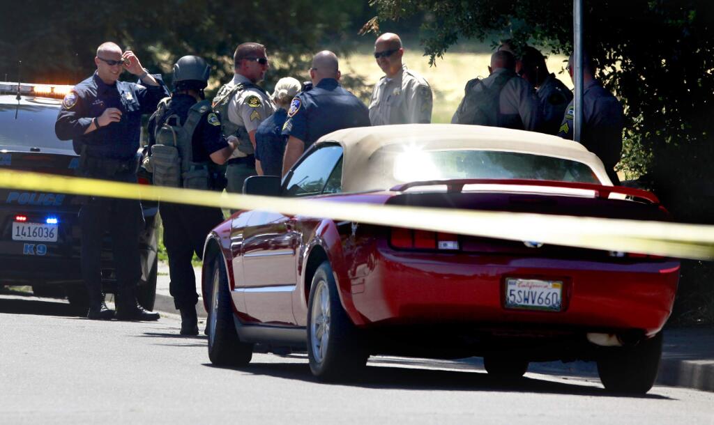 Law enforcement search for a suspect after he left his Ford Mustang on Tachevah Dr. after a robbery at Bennett Valley Jewelers in Santa Rosa, on Thursday, July 10, 2014. (BETH SCHLANKER/ The Press Democrat)