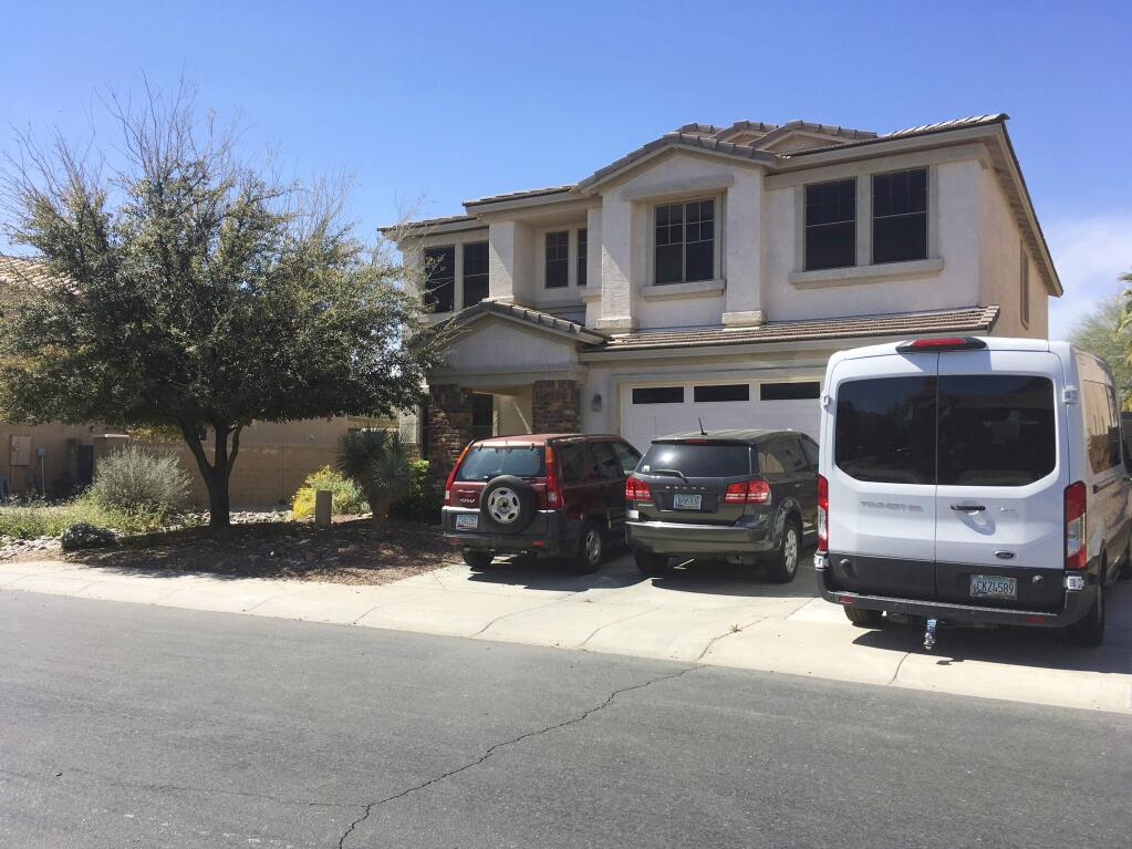 FILE - This March 20, 2019 file photo shows the home of Machelle Hobson in Maricopa, Ariz. Police say Hobson, 48, used pepper spray to discipline her seven adopted children and locked them in a closet without food, water or access to a bathroom for days. Police said the children were punished if they didn't perform as instructed for the family's YouTube channel, which got millions of views across 36 videos. YouTube has terminated the channel, posting a message that it violated its community guidelines. (AP Photo/Terry Tang, File)