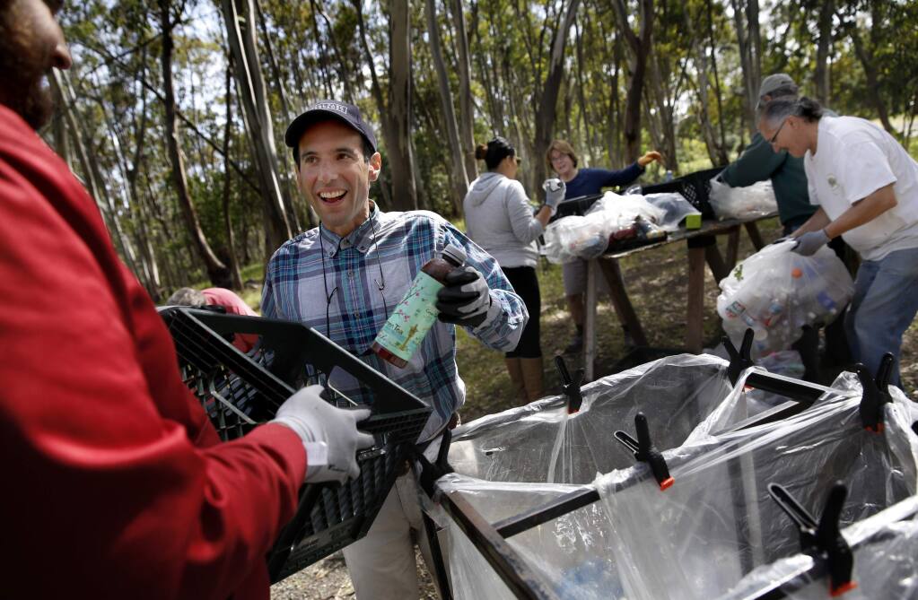 Gabriel de Balmann, who has autism, center, helps recycle bottles with his personal assistant Michael Whitaker, left, from Sweetwater Spectrum, a community for autistic adults, at Jack London State Park in Glen Ellen, on Thursday, April 9, 2015. (BETH SCHLANKER/ The Press Democrat) Sonoma Magazine