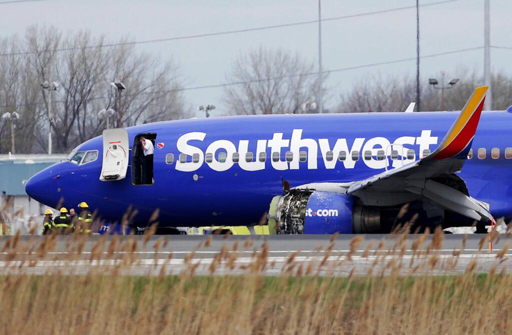 A Southwest Airlines plane sits on the runway at Philadelphia International Airport after it made an emergency landing on Tuesday. (DAVID MAIALETTI / Philadelphia Inquirer)