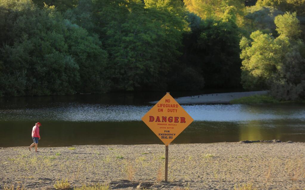Sonoma County health officials will not close the Russian River over Labor Day weekend, despite confirmation that a dangerous algae was behind the death of a dog that swam in the river last weekend. County health officials urge visitors to keep their dogs away from the river. (Kent Porter / Press Democrat)